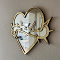 Lekky Studio's Exclusive Heart Mirror: Unique thorn design in traditional tattoo style, with luxurious gold and silver accents. Size: 29x22cm. Hand-assembled, laser-cut acrylic for a bespoke artistic touch to your decor.